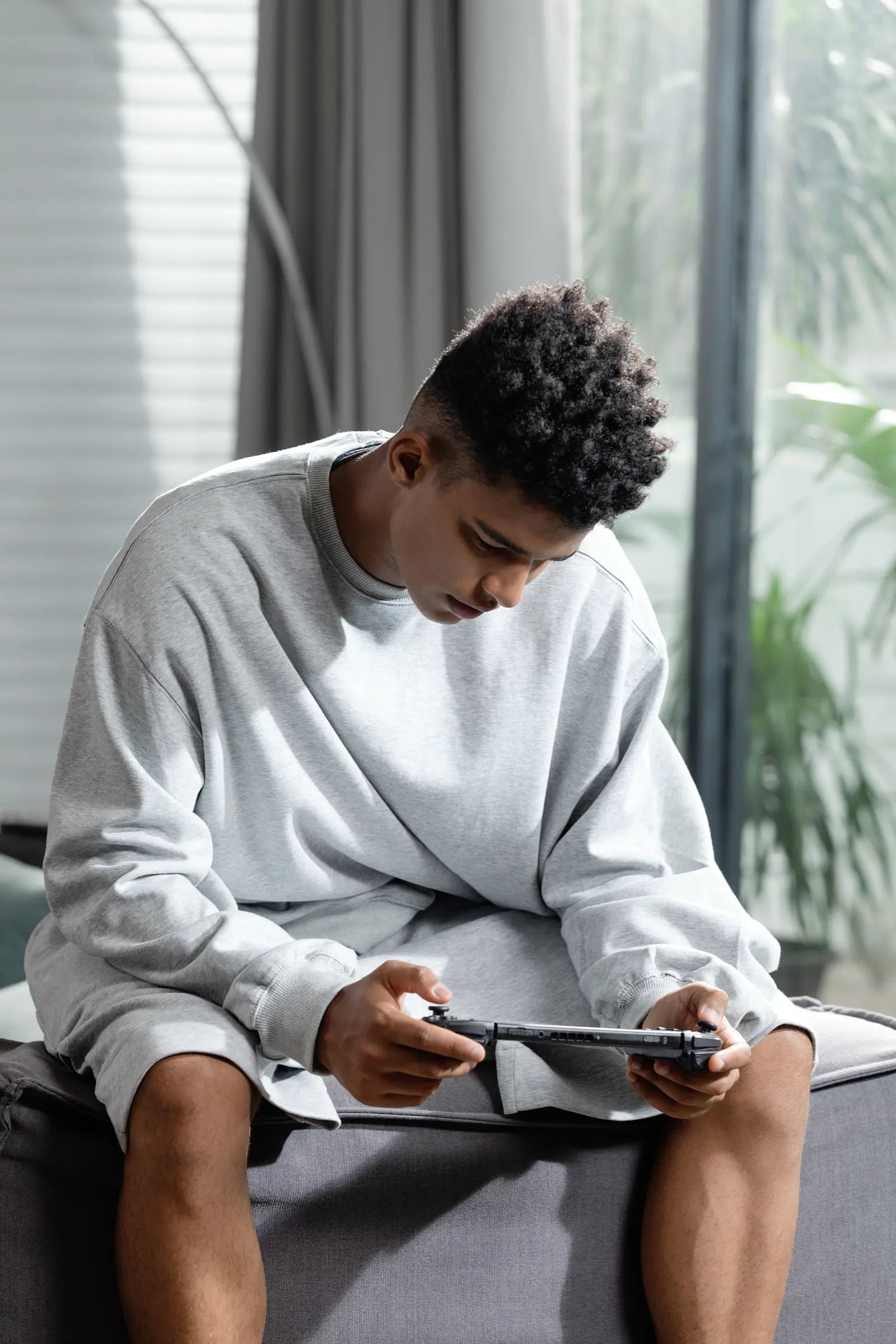 IINE player focused on a handheld gaming session