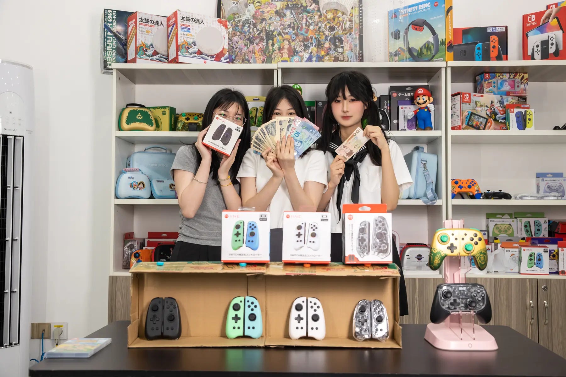 IINE team members presenting controllers and Nintendo Switch accessories